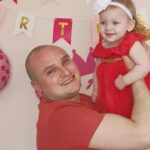 man holding his daughter